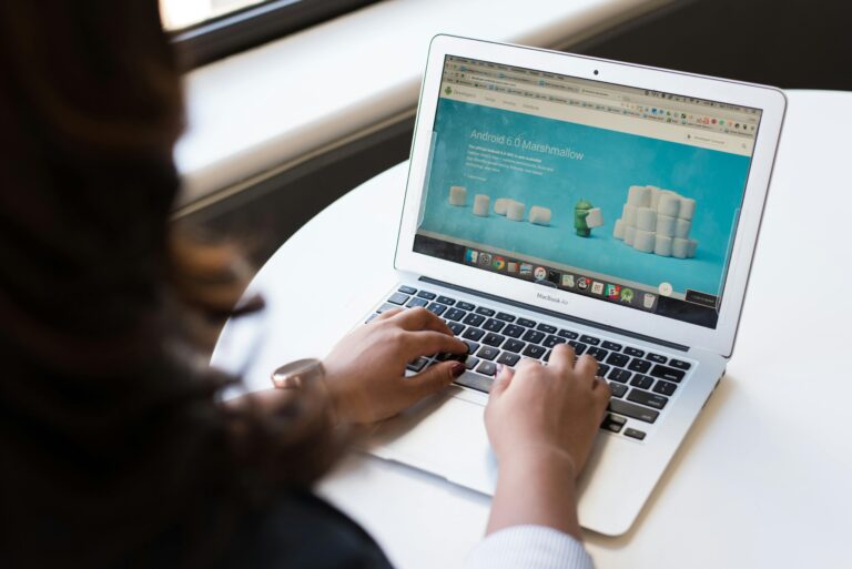 A woman scrolling through a site on her laptop
