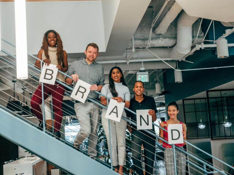 A team forming the word "brand"